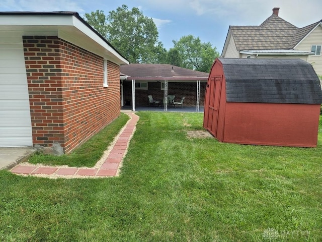 612 E Market St, Xenia, OH 45385 - view of green lawn featuring a storage unit and a patio area