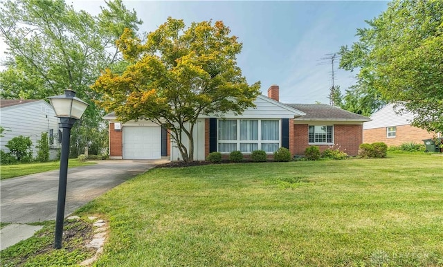 928 E Stroop Rd, Kettering, OH 45429 - view of front of house featuring concrete driveway, a front lawn, brick siding, a chimney, and a garage