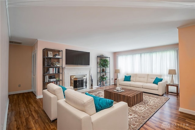 928 E Stroop Rd, Kettering, OH 45429 - living room with wood finished floors, a fireplace with flush hearth, and crown molding