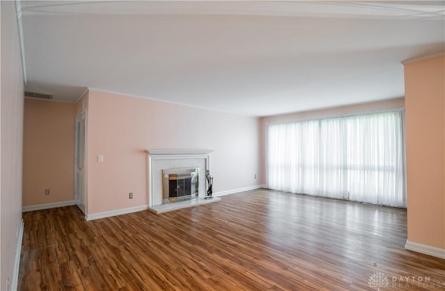 928 E Stroop Rd, Kettering, OH 45429 - unfurnished living room featuring wood finished floors, a glass covered fireplace, and ornamental molding