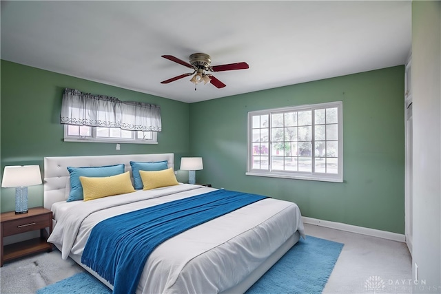 928 E Stroop Rd, Kettering, OH 45429 - carpeted bedroom with multiple windows and ceiling fan