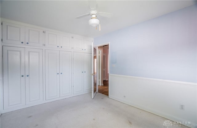928 E Stroop Rd, Kettering, OH 45429 - unfurnished bedroom with a closet, light carpet, and a ceiling fan