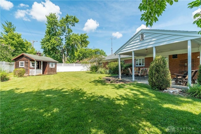 928 E Stroop Rd, Kettering, OH 45429 - fenced backyard featuring an outbuilding and a patio area