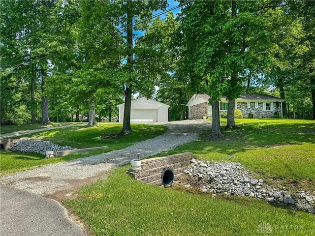 291 Schlitz Dr, Fayetteville, OH 45118 - view of front of home featuring an outdoor structure, a front yard, stone siding, and a garage