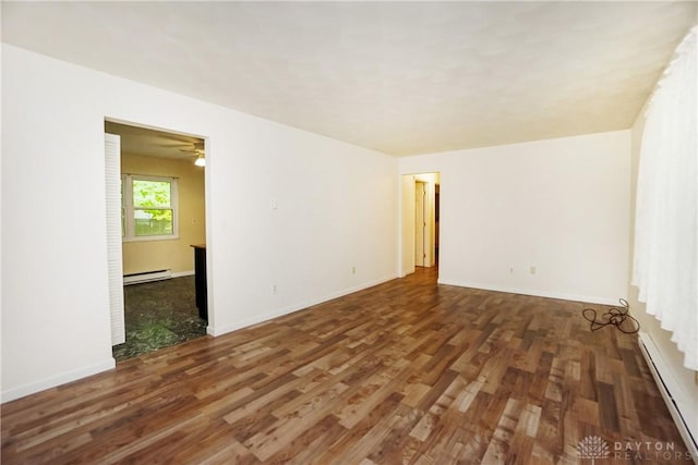 291 Schlitz Dr, Fayetteville, OH 45118 - spare room featuring wood finished floors, a baseboard heating unit, baseboard heating, and a ceiling fan