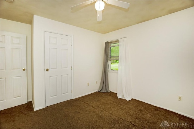 291 Schlitz Dr, Fayetteville, OH 45118 - unfurnished bedroom featuring dark carpet and a ceiling fan