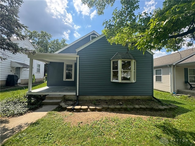 2627 Wayland Ave, Dayton, OH 45420 - rear view of house with a porch and a yard