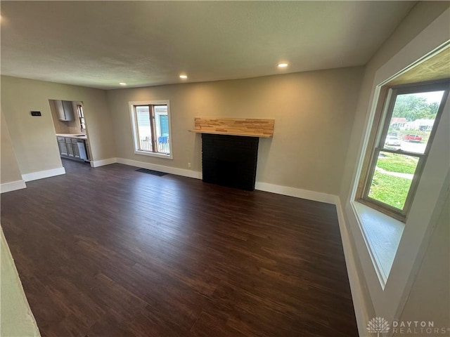 2627 Wayland Ave, Dayton, OH 45420 - unfurnished living room with recessed lighting, dark wood-type flooring, and a fireplace