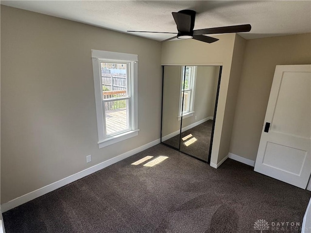 2627 Wayland Ave, Dayton, OH 45420 - unfurnished bedroom featuring dark colored carpet, a closet, and a ceiling fan
