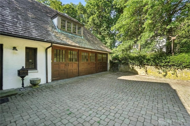715 E Schantz Ave, Oakwood, OH 45419 - view of patio / terrace featuring a garage and decorative driveway