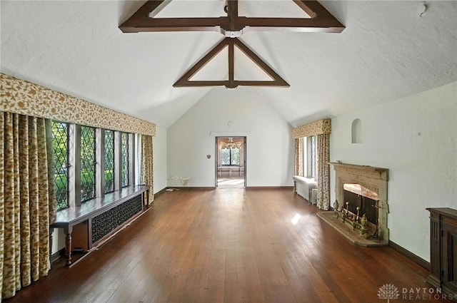 715 E Schantz Ave, Oakwood, OH 45419 - unfurnished living room featuring a fireplace with raised hearth, radiator heating unit, and wood-type flooring