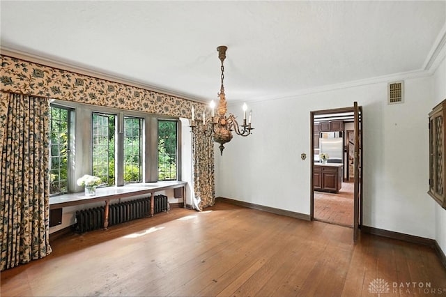 715 E Schantz Ave, Oakwood, OH 45419 - dining room with radiator, a chandelier, crown molding, and light wood finished floors