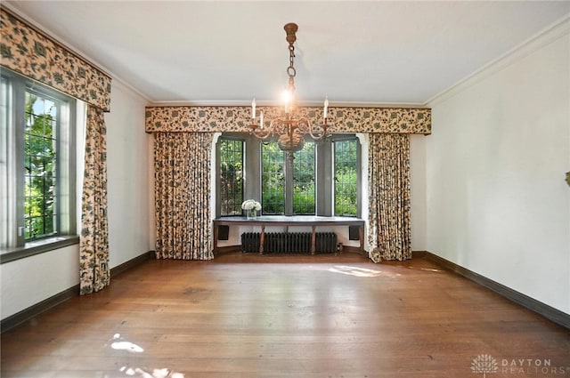 715 E Schantz Ave, Oakwood, OH 45419 - unfurnished dining area featuring radiator, a chandelier, crown molding, and hardwood / wood-style floors