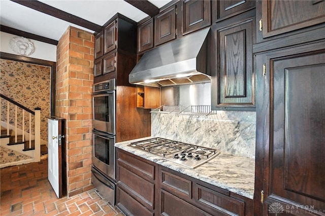 715 E Schantz Ave, Oakwood, OH 45419 - kitchen with appliances with stainless steel finishes, extractor fan, brick floors, decorative backsplash, and a warming drawer