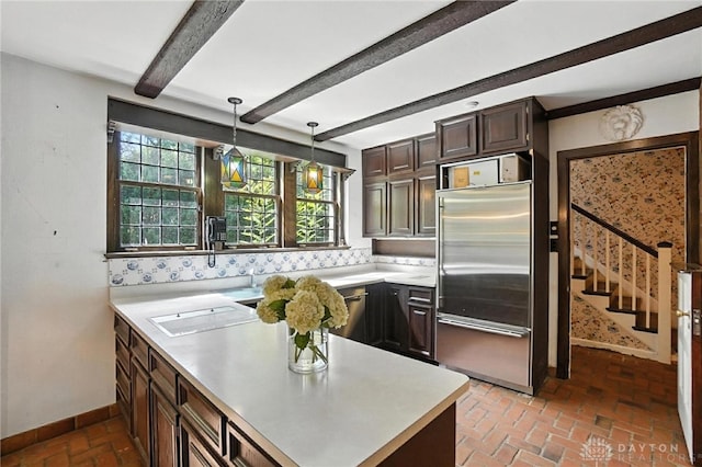 715 E Schantz Ave, Oakwood, OH 45419 - kitchen featuring appliances with stainless steel finishes, light countertops, brick floors, beam ceiling, and dark brown cabinetry