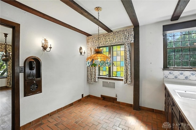 715 E Schantz Ave, Oakwood, OH 45419 - unfurnished dining area with brick flooring and beam ceiling