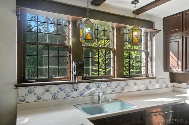 715 E Schantz Ave, Oakwood, OH 45419 - kitchen with light countertops, decorative light fixtures, beamed ceiling, and dark brown cabinetry