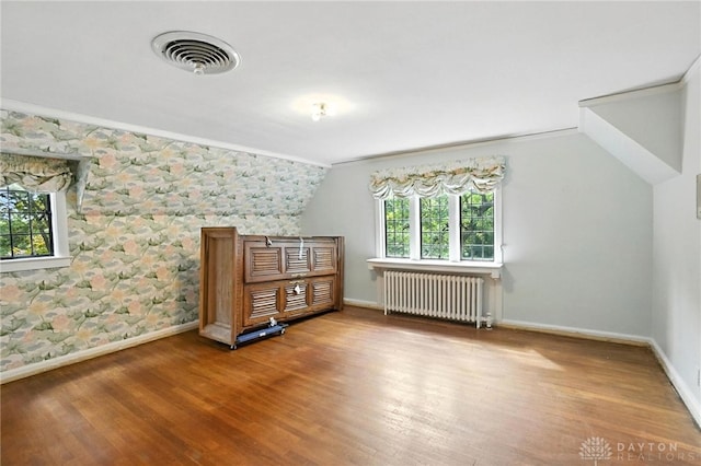 715 E Schantz Ave, Oakwood, OH 45419 - additional living space featuring radiator heating unit, wallpapered walls, wood finished floors, and lofted ceiling