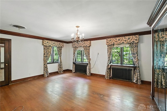715 E Schantz Ave, Oakwood, OH 45419 - unfurnished room with radiator, a chandelier, wood finished floors, and ornamental molding