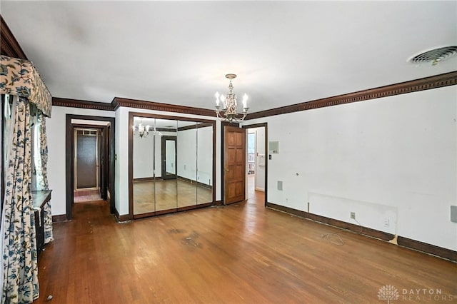 715 E Schantz Ave, Oakwood, OH 45419 - spare room featuring a chandelier, ornamental molding, and wood finished floors