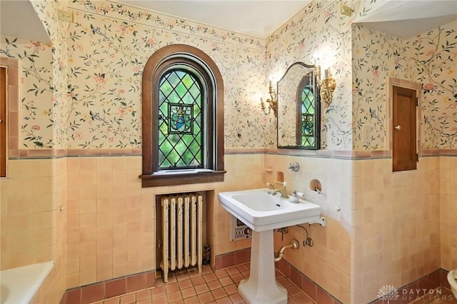 715 E Schantz Ave, Oakwood, OH 45419 - full bathroom with radiator heating unit, tile walls, wainscoting, tile patterned flooring, and a bathtub