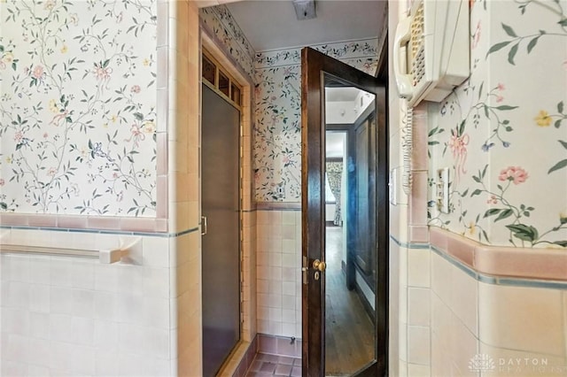 715 E Schantz Ave, Oakwood, OH 45419 - bathroom featuring wallpapered walls, tile walls, a wainscoted wall, and a stall shower