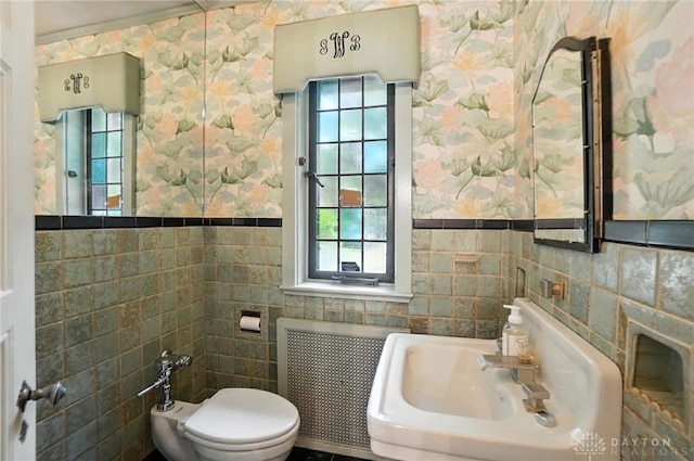 715 E Schantz Ave, Oakwood, OH 45419 - bathroom with radiator, tile walls, wallpapered walls, plenty of natural light, and a bidet