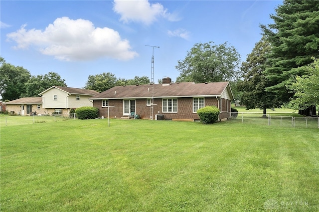 2042 Hilltop Rd, Xenia, OH 45385 - back of house featuring brick siding, a fenced backyard, and a chimney