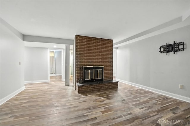 2042 Hilltop Rd, Xenia, OH 45385 - unfurnished living room with wood finished floors and a fireplace