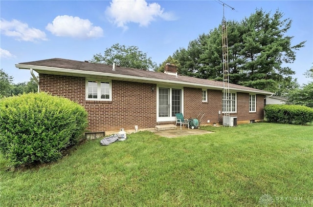 2042 Hilltop Rd, Xenia, OH 45385 - rear view of house featuring brick siding, a chimney, and a lawn