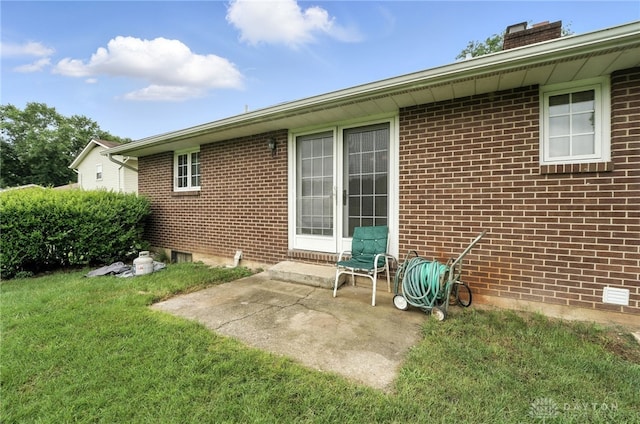 2042 Hilltop Rd, Xenia, OH 45385 - rear view of property with a lawn, a chimney, brick siding, and a patio area