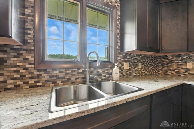 2042 Hilltop Rd, Xenia, OH 45385 - kitchen featuring backsplash and dark brown cabinets