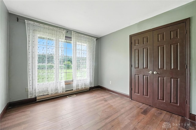 2042 Hilltop Rd, Xenia, OH 45385 - unfurnished bedroom featuring wood finished floors and a closet