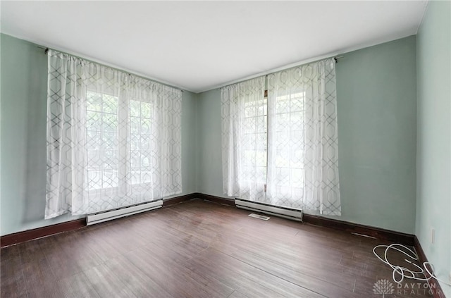 2042 Hilltop Rd, Xenia, OH 45385 - unfurnished room featuring a baseboard heating unit and wood finished floors