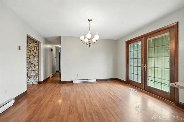2042 Hilltop Rd, Xenia, OH 45385 - empty room with a baseboard heating unit, a chandelier, baseboard heating, and healthy amount of natural light