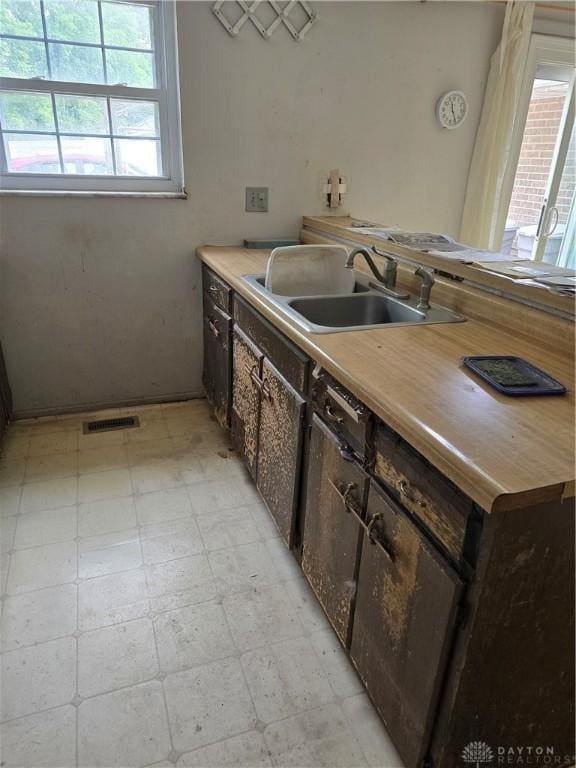 4801 Creeknoll Ct, Dayton, OH 45424 - kitchen with light flooring, dark brown cabinetry, and light countertops