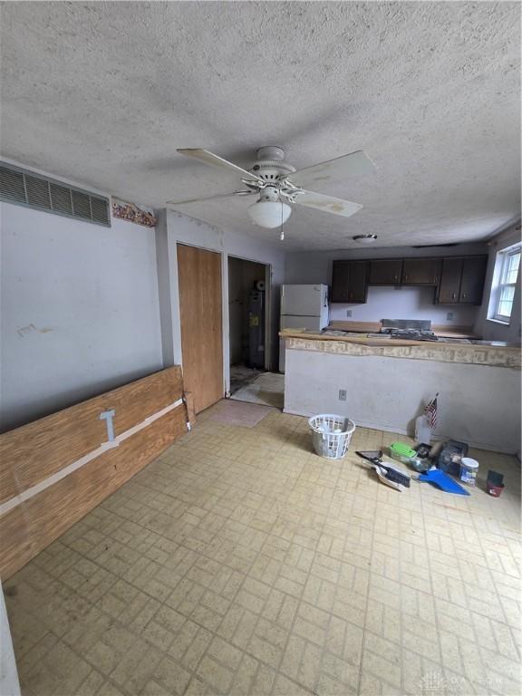 4801 Creeknoll Ct, Dayton, OH 45424 - unfurnished living room featuring a ceiling fan, brick patterned flooring, and a textured ceiling