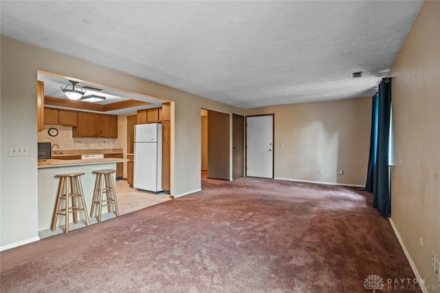 8869 Washington Colony Dr, Dayton, OH 45458 - unfurnished living room featuring light carpet and a textured ceiling