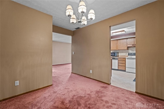 8869 Washington Colony Dr, Dayton, OH 45458 - unfurnished room with a chandelier and light colored carpet