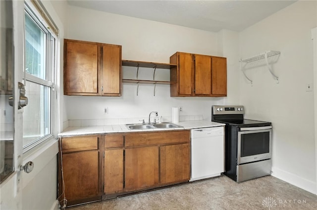 38-40 Greenwood Ave, Dayton, OH 45410 - kitchen with dishwasher, electric stove, open shelves, and brown cabinets