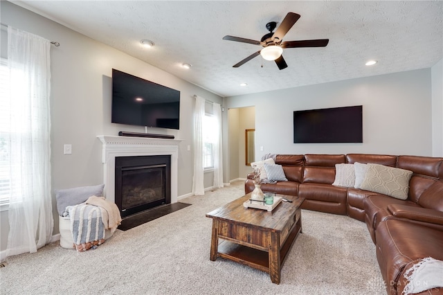 2937 E Ambrosia Ln, Xenia, OH 45385 - carpeted living room featuring ceiling fan, a fireplace with flush hearth, recessed lighting, and a textured ceiling