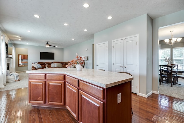 2937 E Ambrosia Ln, Xenia, OH 45385 - kitchen with dark wood finished floors, ceiling fan, light countertops, recessed lighting, and a chandelier