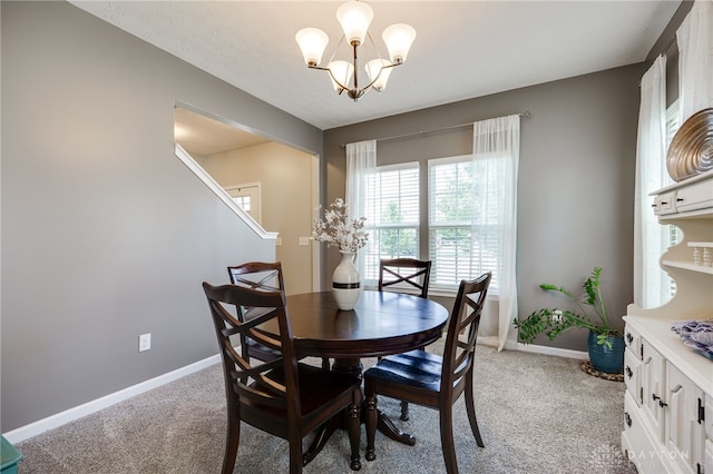 2937 E Ambrosia Ln, Xenia, OH 45385 - dining area with light carpet, a chandelier, and stairway