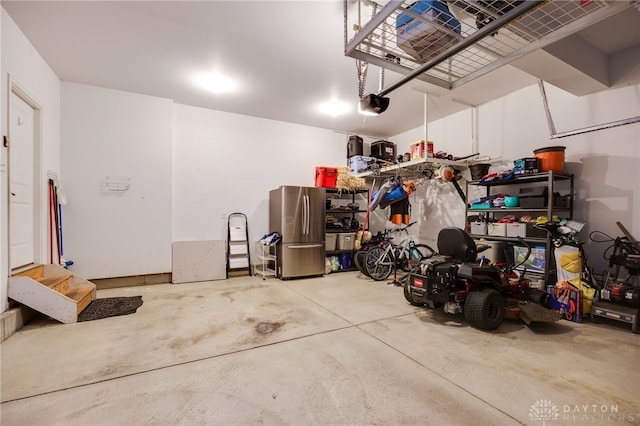 2937 E Ambrosia Ln, Xenia, OH 45385 - garage with freestanding refrigerator and a garage door opener