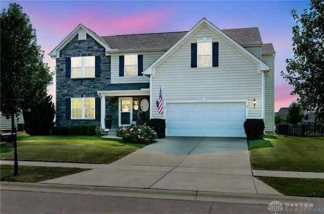 2937 E Ambrosia Ln, Xenia, OH 45385 - traditional home with stone siding, concrete driveway, and an attached garage