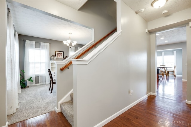 2937 E Ambrosia Ln, Xenia, OH 45385 - stairs featuring wood finished floors, plenty of natural light, and a chandelier