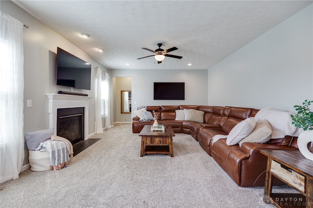 2937 E Ambrosia Ln, Xenia, OH 45385 - living room with carpet floors, ceiling fan, a fireplace with flush hearth, recessed lighting, and a textured ceiling