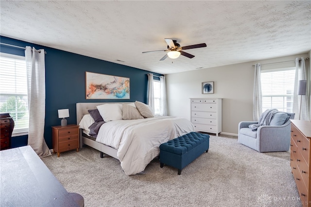 2937 E Ambrosia Ln, Xenia, OH 45385 - bedroom featuring light carpet, ceiling fan, and a textured ceiling
