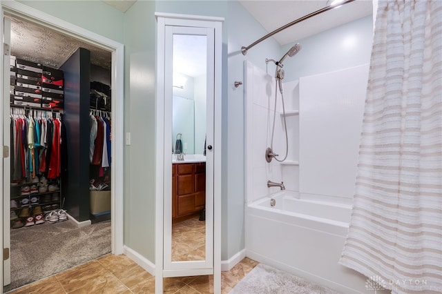 2937 E Ambrosia Ln, Xenia, OH 45385 - bathroom featuring shower / bath combination with curtain, vanity, a spacious closet, and tile patterned floors
