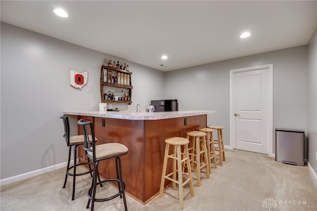 2937 E Ambrosia Ln, Xenia, OH 45385 - indoor wet bar featuring light colored carpet, recessed lighting, and freestanding refrigerator